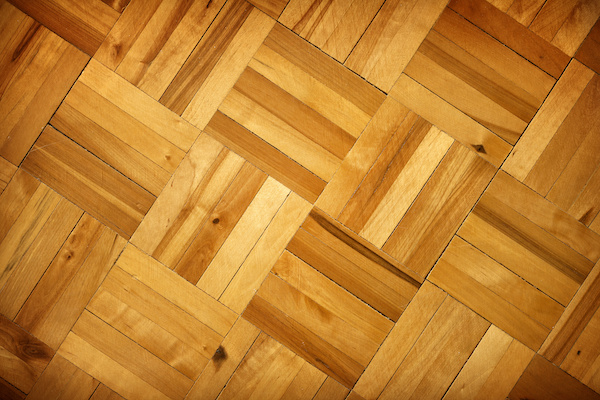 brown wooden floorboards in a parquet pattern