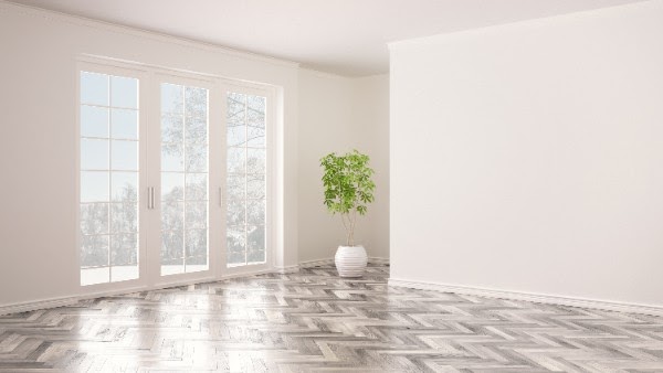 gray herringbone hardwood floor pattern in room with french doors