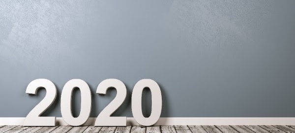 large 2020 numbers on a light gray wood floor in front of light blue wall