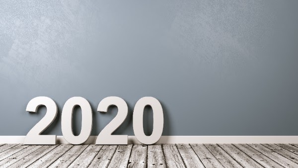large 2020 numbers on a light gray wood floor in front of light blue wall